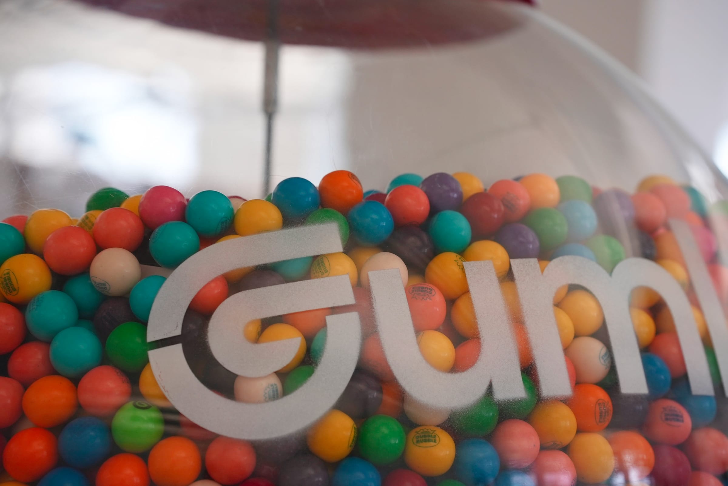 A close-up of the Gumloop-branded gumball machine in the office