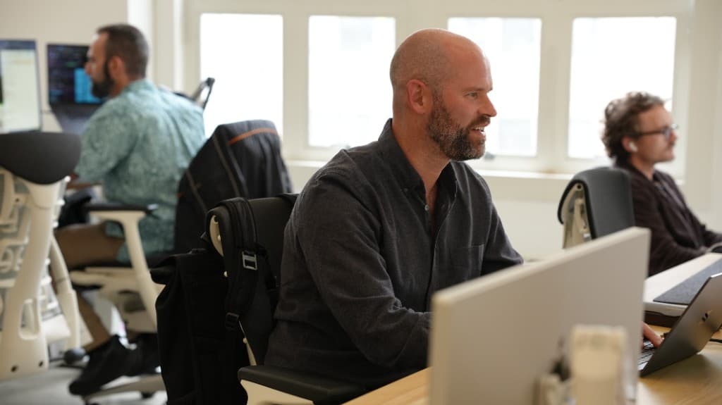 Gumloopers working side by side on the open office floor